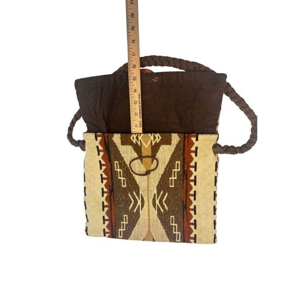 This is a bohemian-style shoulder bag with a braided strap. - Picture 8 of 8